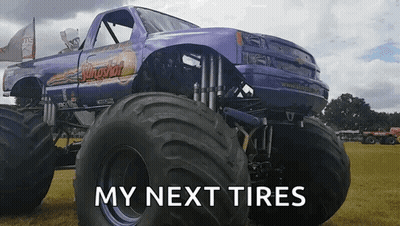 A Purple Monster Truck Is Parked In A Grassy Field With The Words " My Next Tires " Below It GIF