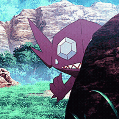 A Purple Monster With A Diamond In Its Eye Is Standing Next To A Large Rock . GIF