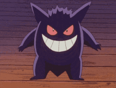 A Purple Monster With Red Eyes Is Smiling On A Wooden Surface GIF