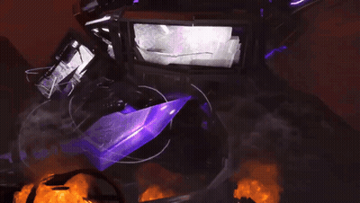 A Purple Object Is Surrounded By Fire And Smoke In A Dark Room GIF
