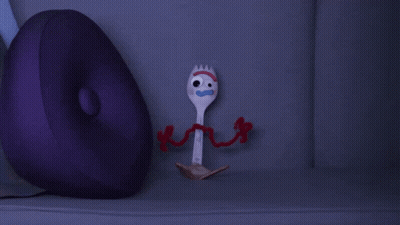 A Purple Pillow Sits Next To A Toy Fork From Toy Story GIF