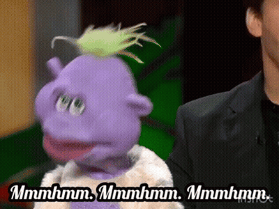A Purple Puppet Is Standing Next To A Man In A Suit And Says Mmmmhm GIF