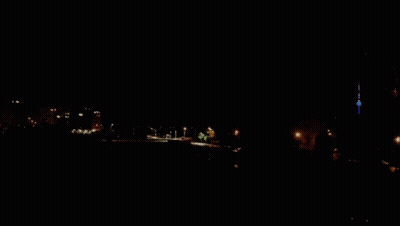 A Purple Sky With A Few Clouds And A Tower In The Distance GIF