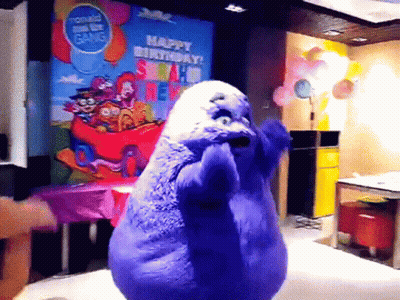 A Purple Stuffed Animal Is Dancing In Front Of A Sign That Says Happy Birthday Mcdonald 'S GIF