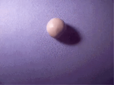 A Purple Surface With A White Ball On It GIF