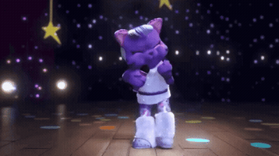 A Purple Teddy Bear Is Dancing On A Disco Floor GIF
