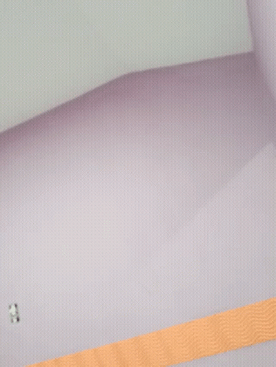 A Purple Wall With An Orange Stripe On The Bottom GIF