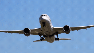 A Qatar Airplane Is Flying Through A Clear Blue Sky GIF