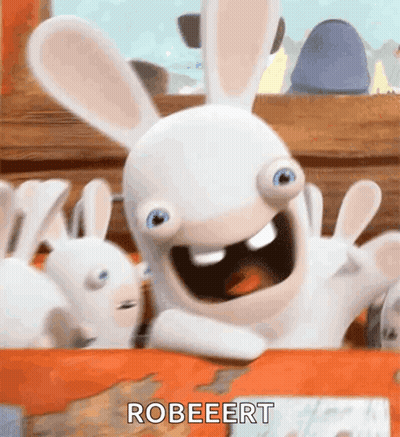 A Rabbit From The Video Game Rabbids Is Sitting On A Table With Its Arms Outstretched . GIF
