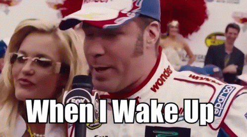 A Race Car Driver Is Talking Into A Microphone With The Words When I Wake Up Behind Him GIF