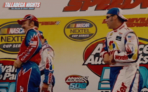 A Race Car Driver Stands On A Podium Sponsored By Nascar Nextel And Advanced Auto Parts GIF