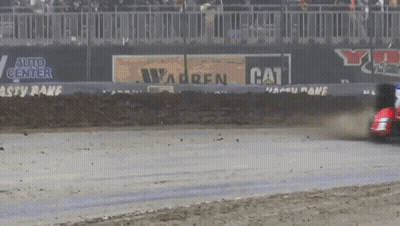A Race Car Is Driving Down A Track With A Cat Advertisement In The Background GIF