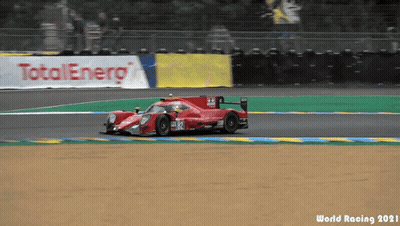A Race Car Is Driving On A Track With A Total Energy Banner Behind It GIF