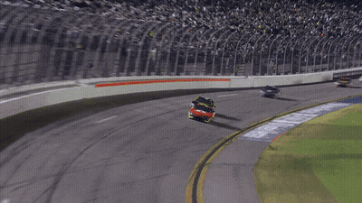 A Race Car Is Going Around A Curve In A Race GIF