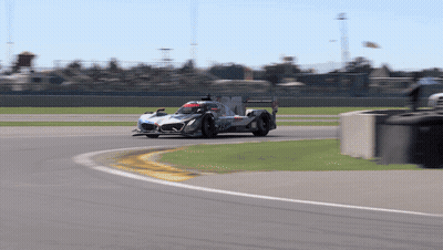 A Race Car Is Going Around A Curve On The Track GIF
