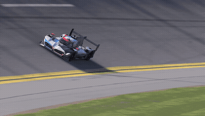 A Race Car Is Going Around A Curve With A Yellow Line On The Side GIF