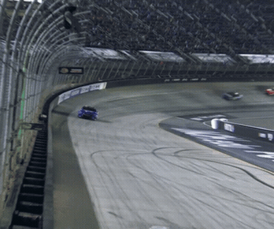 A Race Car Is Going Around A Track With A Sign That Says ' Chase ' GIF