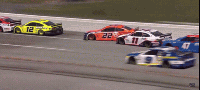 A Race Car With The Number 12 On The Side Of It GIF