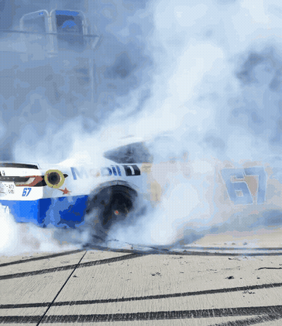 A Race Car With The Number 67 On It Is Smoking GIF