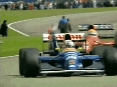 A Race Car With The Word Dhl On The Side Is Driving Down A Track GIF