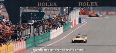 A Race Track With A Sign That Says Rolex In The Background GIF