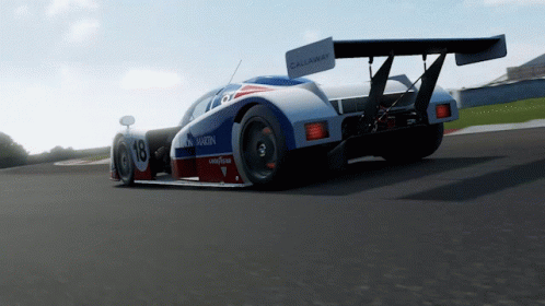 A Racing Car With The Number 18 On It GIF