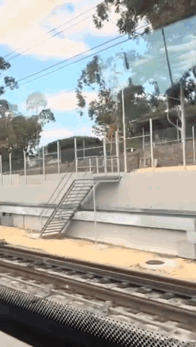 A Railroad Track With A Staircase On The Side GIF