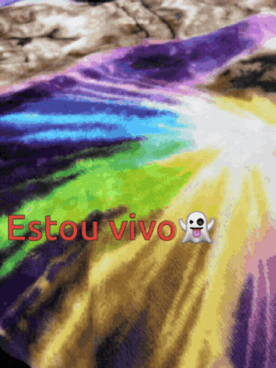 A Rainbow Colored Blanket With The Words Estou Vivo Written On It GIF