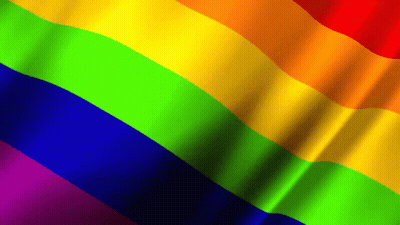 A Rainbow Flag Is Waving In The Wind With A Black Background GIF
