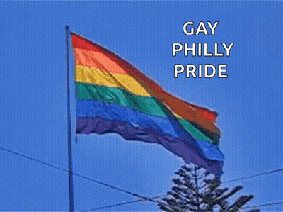 A Rainbow Flag With The Words Gay Philly Pride Written Above It GIF