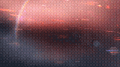 A Rainbow Is Visible In The Middle Of A Dark Background GIF