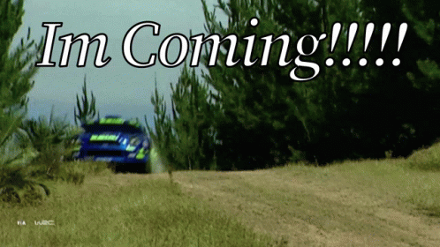 A Rally Car Is Driving Down A Dirt Road With The Words " Im Coming " Written Above It GIF