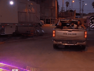 A Ram Truck Is Parked In A Parking Lot At Night GIF