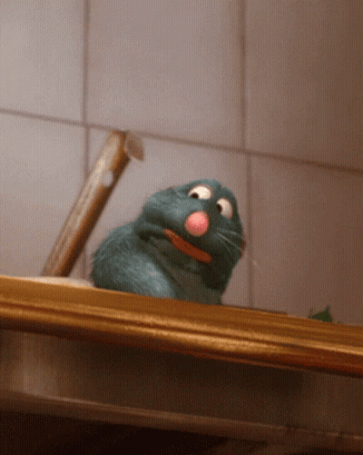A Rat With A Pink Nose Is Sitting On A Wooden Shelf GIF