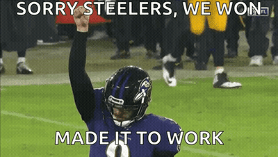 A Ravens Football Player Holds His Fist In The Air GIF