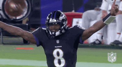 A Ravens Football Player Is Celebrating With His Arms Outstretched . GIF