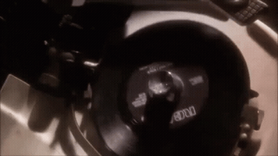 A Record Player Is Playing A Record On A Turntable . GIF