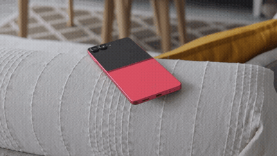 A Red And Black Cell Phone Is Laying On A White Couch GIF