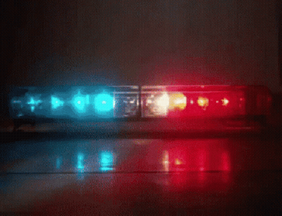 A Red And Blue Police Light Is Sitting On The Floor GIF