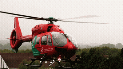 A Red And Green Helicopter With The Word Northern Ireland On The Side GIF