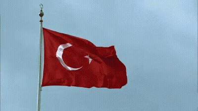 A Red And White Flag With A Crescent Moon And Star On It GIF