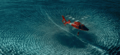 A Red And White Helicopter Is Floating In The Ocean GIF