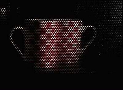 A Red And White Mug Is Visible Through A Microwave Door GIF