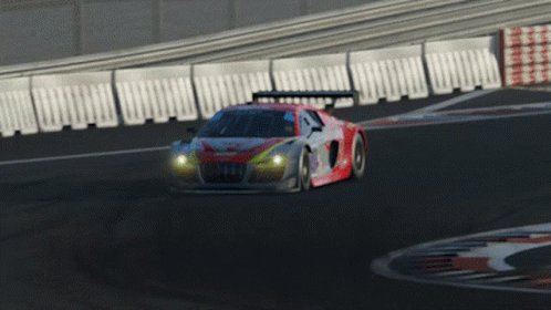 A Red And White Race Car Is Driving Down A Road GIF