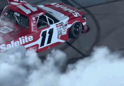 A Red And White Race Car With The Number 11 On The Side GIF