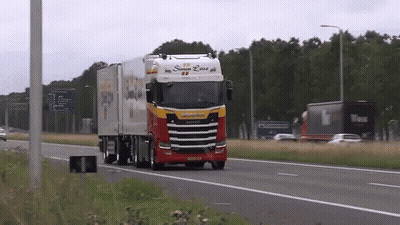 A Red And White Truck With The Word Scania On The Side GIF