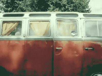 A Red And White Van With A Smiley Face On The Window GIF
