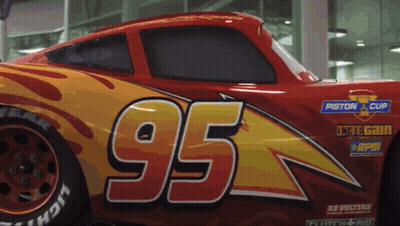 A Red And Yellow Car With The Number 95 On The Side GIF