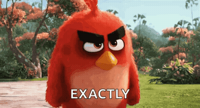 A Red Angry Bird From The Angry Birds Movie Is Standing In A Grassy Field . GIF