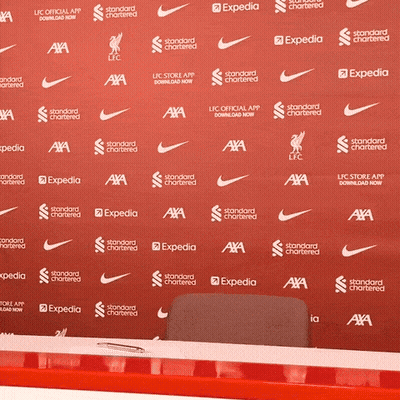 A Red Backdrop With Nike And Expedia Written On It GIF